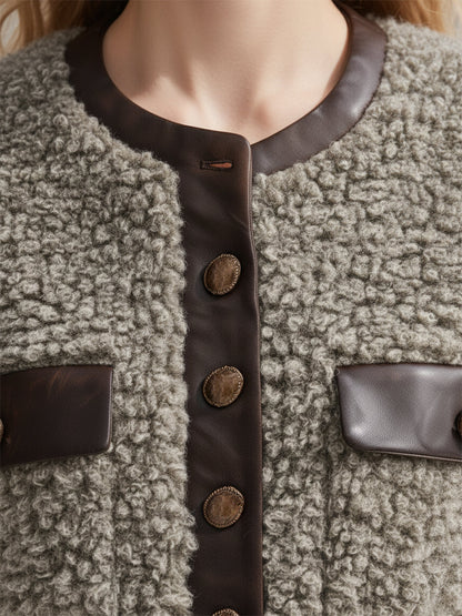 Veste en fausse fourrure à col rond avec élégantes finitions en simili cuir vintage